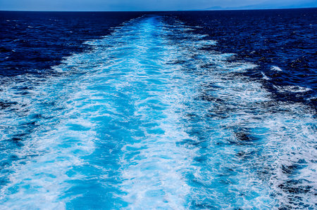 The water is blue and the waves are small. The water is calm and peacefulの写真素材