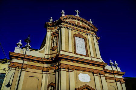 A large, ornate building with a clock on the front. The building appears to be a church, and the clock is prominently displayed on the front. Scene is one of grandeur and importanceの写真素材