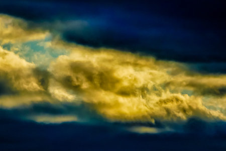 The sky is filled with clouds and the sun is shining through them. The clouds are a mix of blue and...