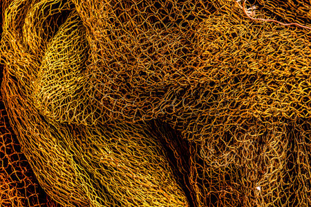 A close up of a piece of fabric with a lot of texture and a lot of gold. The fabric is very thick...