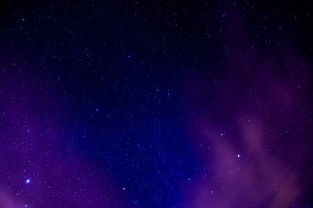 A dark purple sky with many stars. The stars are scattered throughout the sky, creating a sense of...