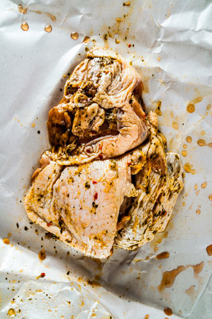 A piece of meat is covered in spices and sauce. The sauce is brown and has a slightly burnt smellの写真素材