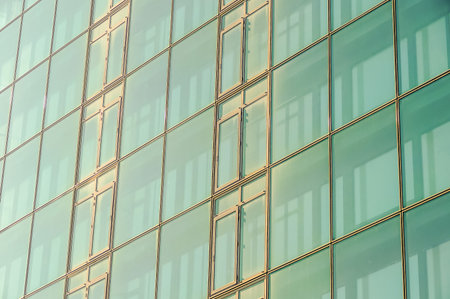 A building with a lot of windows and a lot of gold. The windows are clear and the building is very tallの写真素材