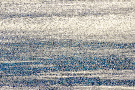 A blurry blue and white striped surface. The surface has a textured pattern.の写真素材