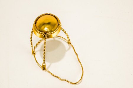 A gold colored object with a wire frame. It is a small, round object with a wire frameの写真素材