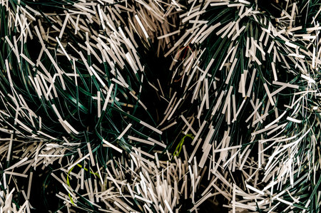 A close up of a Christmas tree with green and white branches. The branches are scattered and the tree appears to be fakeの写真素材