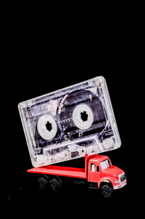 Music Concept Red Truck and Audio Music Tape on a Black Backgroundの写真素材