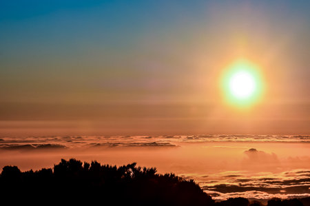 Sun Star on a Blue Sky over a Mountain Silhouette in Gran Canaria Spainの写真素材
