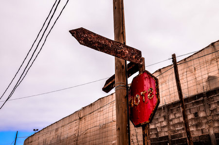 Vintage Old Rusty Road Sign Consumed by the Timeの写真素材