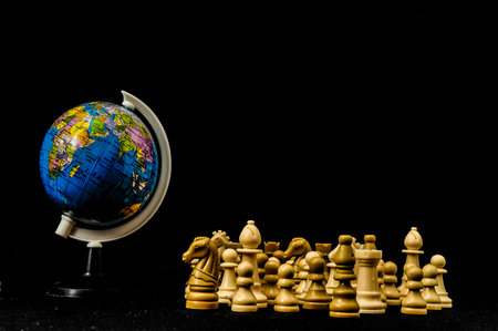 Globe And White Chess on a Black Backgroundの写真素材