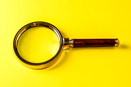 Vintage Magnify Glass Loupe on a Colored Backgroundの写真素材
