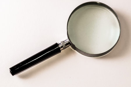 Vintage Magnify Glass Loupe on a White Backgroundの写真素材