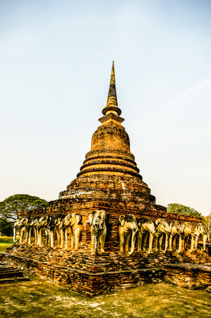 A large, ancient building with a tall spire and a multitude of statues of elephants adorning its exterior. The building appears to be a temple or a religious structureの写真素材