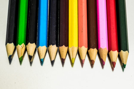 A row of pencils with different colors. The pencils are lined up next to each otherの写真素材