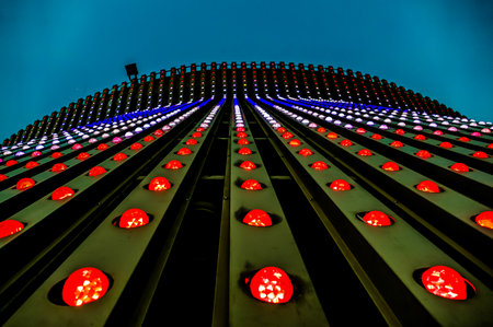 A building with a large number of red lights on it. The lights are arranged in a way that creates a sense of movement and energy. Scene is dynamic and livelyの写真素材