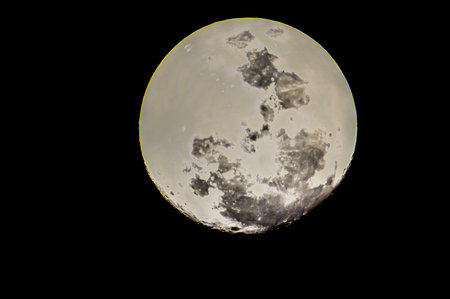A large moon with a white and black surface. The moon is in the middle of the image