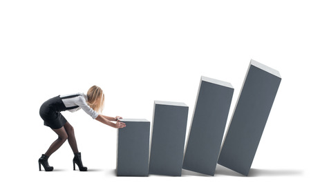 Woman pushing away blocks isolated on white backgroundの写真素材