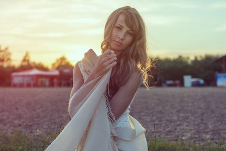 Sunny outdoors portrait of a beautiful young romantic woman or girl under sunset  Summer evening nature  Soft light  Photo toned in warm colors style instagram filtersの写真素材