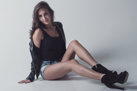 Beautiful and attractive young adult female brunette sensuality woman posing in casual clothesの写真素材