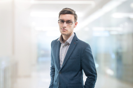Young confident businessman standing in the office with serious intentions.の写真素材