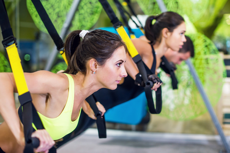 People at gym doing elastic rope exercises Concept sport workout fitness healthy lifestyle.の写真素材