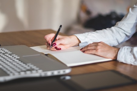 businesswoman with laptop and diary in office concept freelance work at homeの写真素材