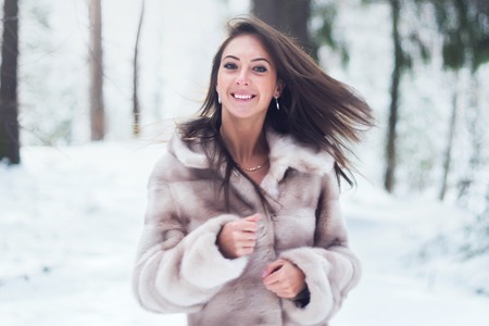 Portrait of young woman walk in nature winter woodsの写真素材