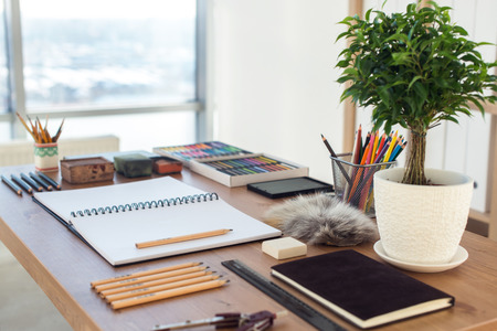Side view of a painter workspace. Wooden desk with artistic tools prepared for pastel drawingの写真素材