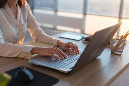 Female teleworker texting using laptop and internet, working online. Freelancer typing at home...