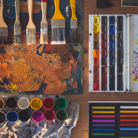 Painting tools: gouache, watercolor, crayons set, palette and paintbrush collection arranged, prepared for drawing in art studioの写真素材