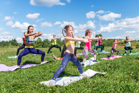 Group of women exercising and doing squats at boot campの写真素材