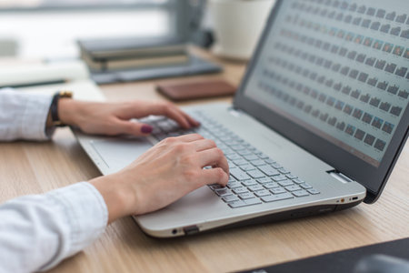 Working with laptop woman writing a blog. Female hands on the keyboard