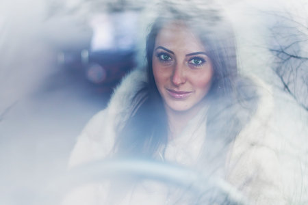Portrait of beautiful smilling woman car driver.の写真素材