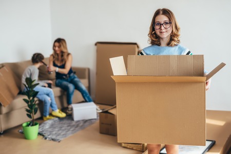Family unpacking cardboard boxes at new homeの写真素材