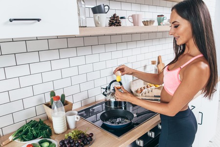 Young smiling woman preparing healthy breakfast. Diet, fitness and wellbeing.の写真素材