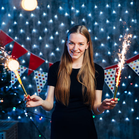 Girl celebrating new years eve with bengal light. Christmasの写真素材