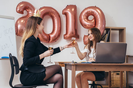 Two business women having party at office