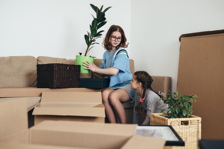 Family unpacking cardboard boxes at new homeの写真素材