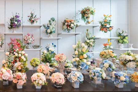 Decorative bouquets of colorful flowers on the shop showcase