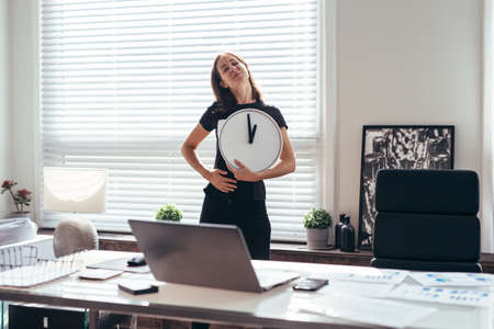 Woman is stroking her belly, it is time for lunch and she is hungry.の写真素材