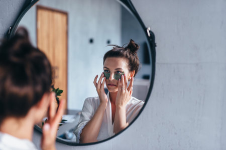 Young woman takes care of her facial skin at home