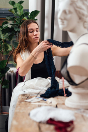 Girl sitting at a table holding tissues