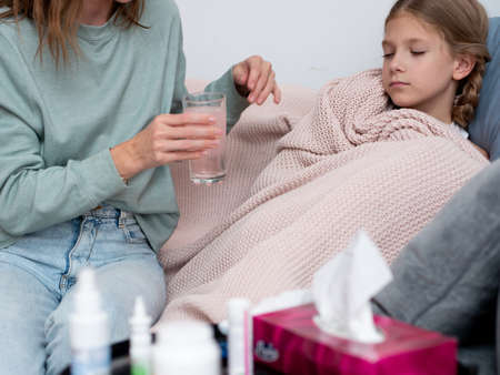 Mother prepared a medicinal drink for her daughter who had a coldの写真素材