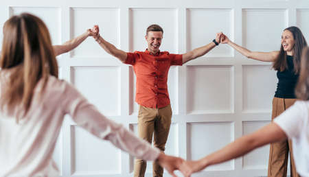 People hold hands, play and have funの写真素材