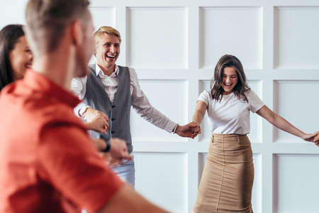 People walk in a circle holding handsの写真素材