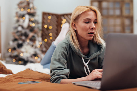 Woman Relaxing On Sofa With Laptop Home.の写真素材