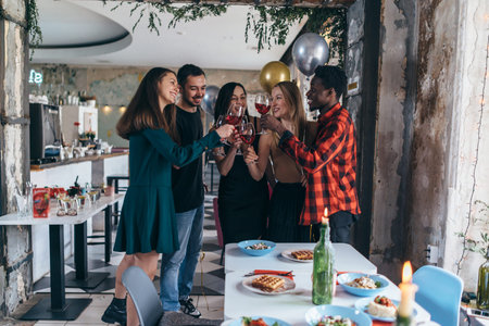 Group of friends celebrating in the bar.の写真素材
