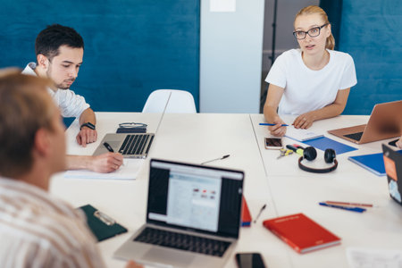 Staff communicate at work by sitting at desk