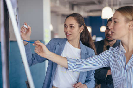 Employees study the data at the information boothの写真素材