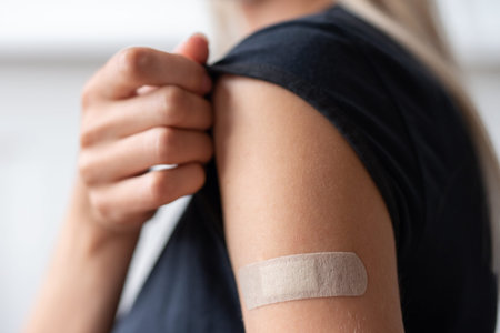 Woman holding her shirt sleeve after receiving vaccination